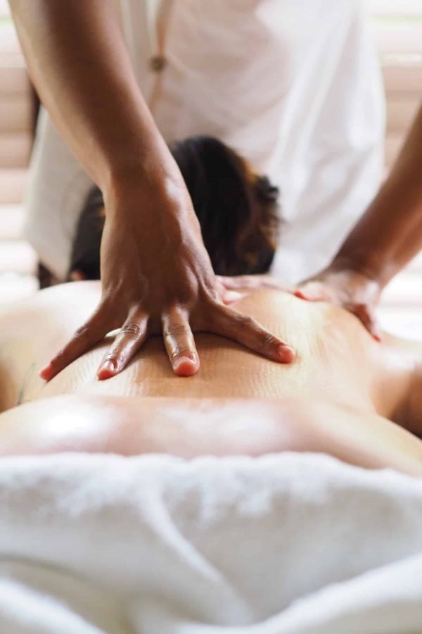 Woman laying on spa massage bed.